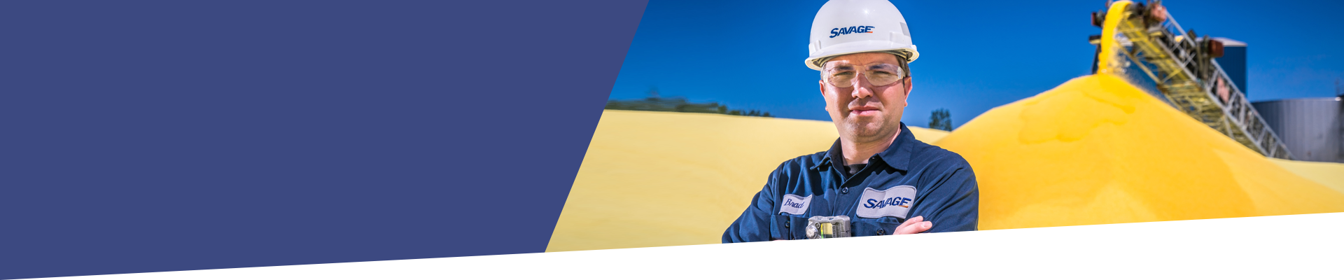 Gusramher Team Member in front of a pile of sulphur.